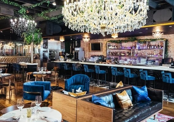 Chic dining room at Felix Culpa, elegant chandeliers for upscale events and gatherings.