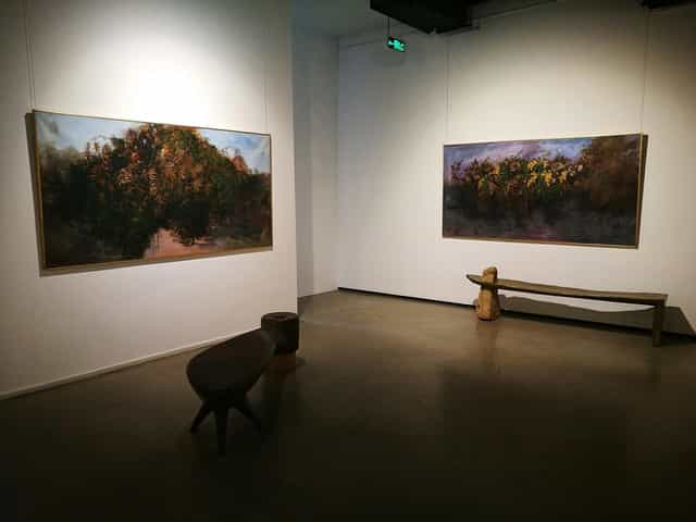 Emerging Artists Exhibition in Gallery Naila with large paintings and serene ambiance.