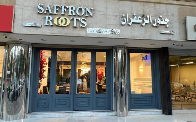 Saffron Roots restaurant entrance with modern façade, ideal for corporate events and gatherings.