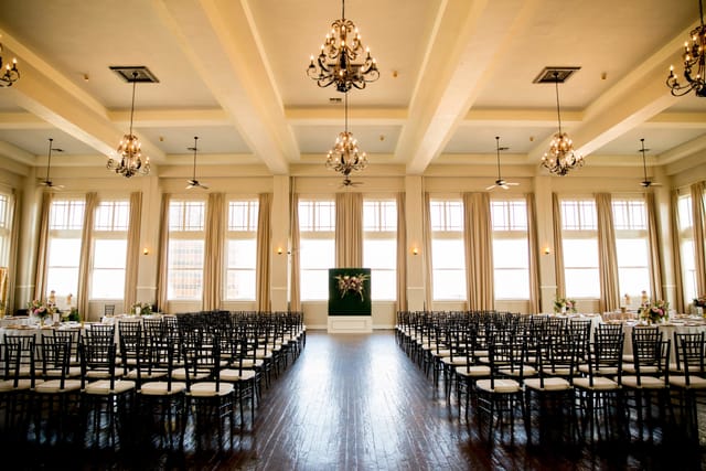 Elegant event space with chandeliers, ideal for weddings and corporate gatherings.