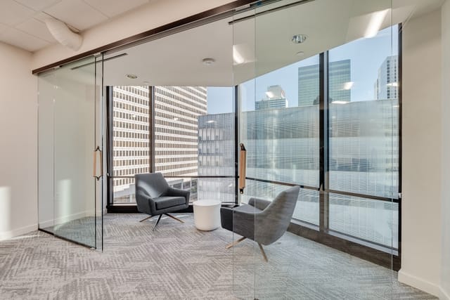 Modern board room with glass walls for meetings and brainstorming sessions in Trammell Crow Center.