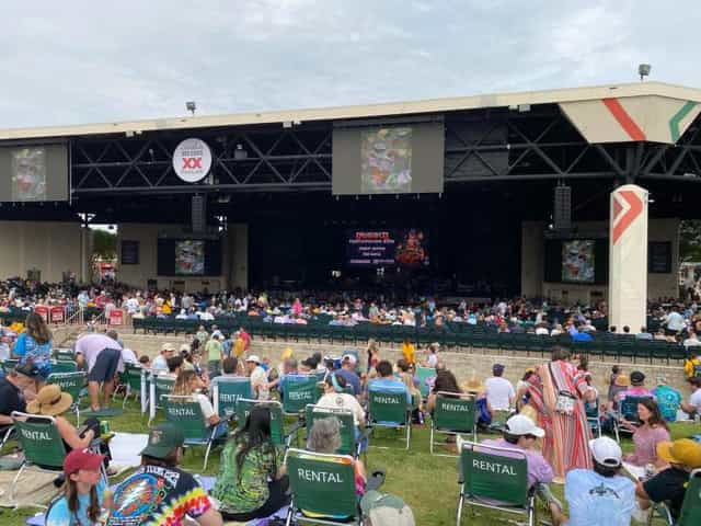 Lawn Area at Dos Equis Pavilion with audience seated for an outdoor performance event.