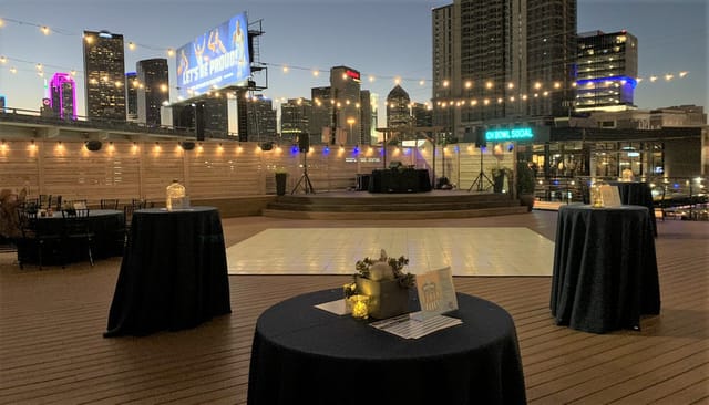 Rooftop deck at Commerce Event Center with elegant tables, perfect for evening events.
