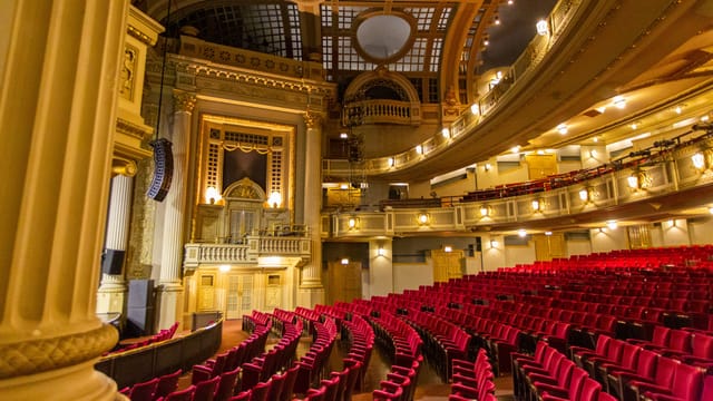 Ornate Majestic Theatre interior with plush seating for conferences and gala events.