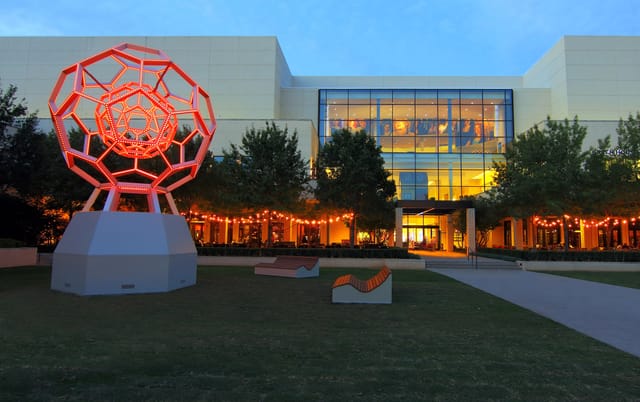 Outdoor shopping mall venue at NorthPark Center with vibrant sculpture for events.