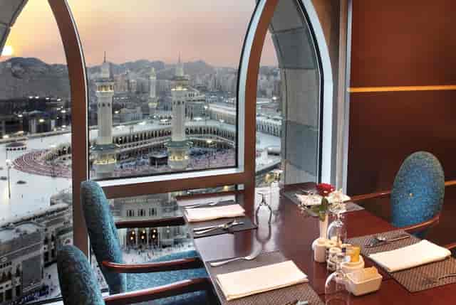 Elegant dining table at Hala Café with Masjid al-Haram view for events and meetings.