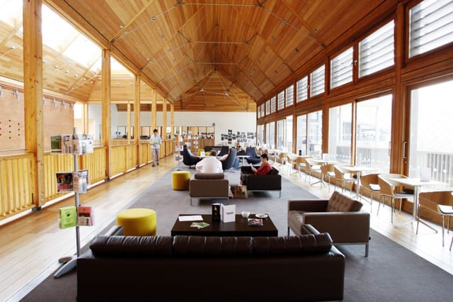 Open lounge in The Apex with natural light, ideal for informal meetings and networking.