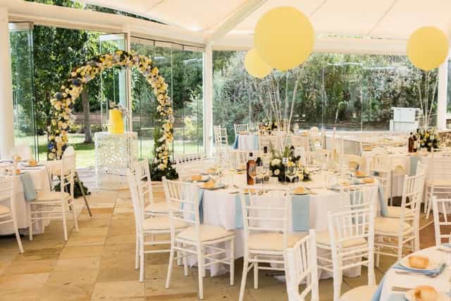 Elegant wedding reception at Sheldon Gardens with floral arch and pastel decor.