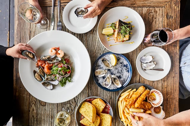 Seafood spread on rustic table at The Brasserie, ideal for networking events and dinners.
