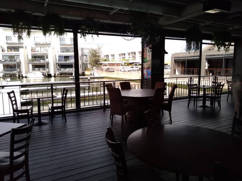 Sports bar at The Cove Hotel with large windows, perfect for events and gatherings.