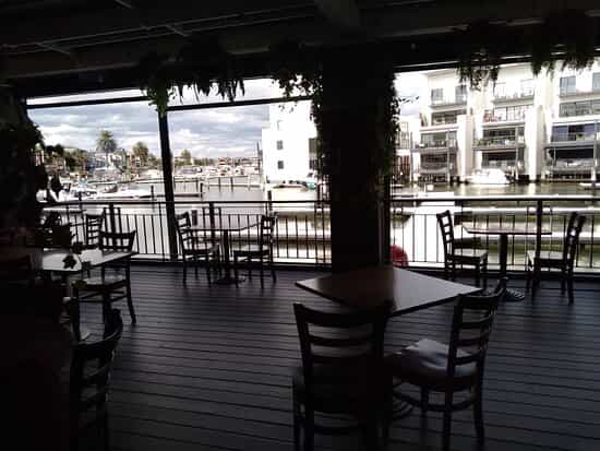 Versatile sports bar with waterfront view, ideal for casual gatherings and networking events.