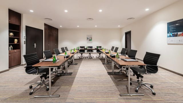 Holiday Inn Al Qasr Riyadh conference room with U-shape desk arrangement for meetings.