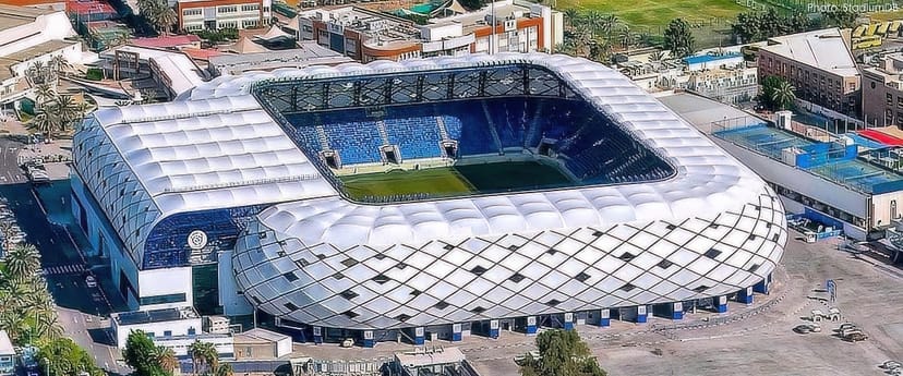 Modern Al Nasr Club Football Stadium with expansive seating for sports and concerts.