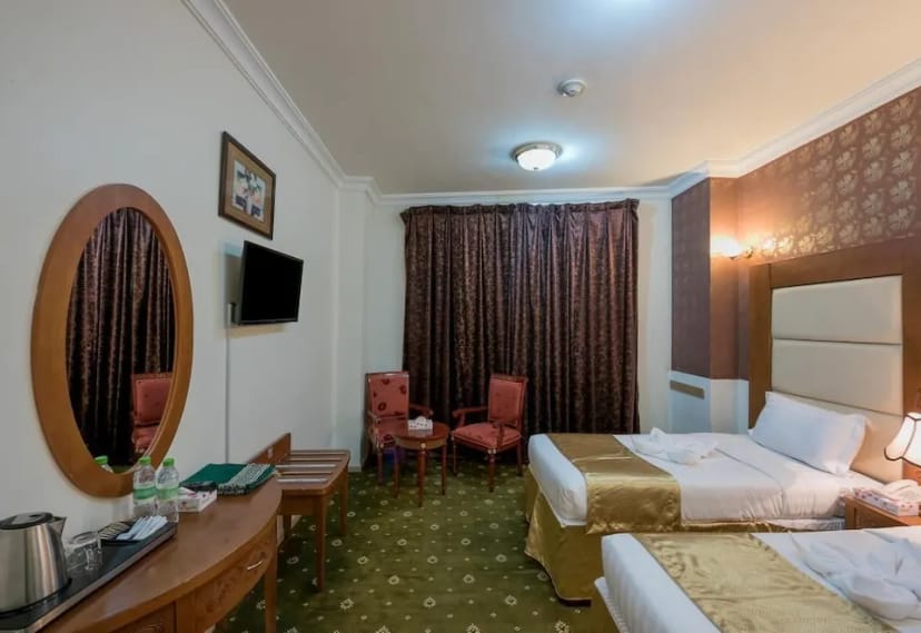 Meeting room at Al Mukhtara Hotel Medina with two single beds, ideal for conferences.