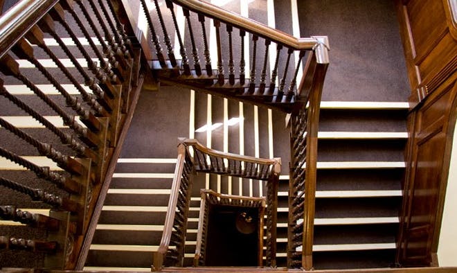 Elegant wooden staircase at Hallam Café, perfect for events and gatherings.