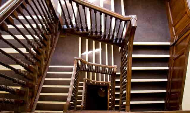 Elegant wooden staircase at Hallam Café, perfect for events and gatherings.