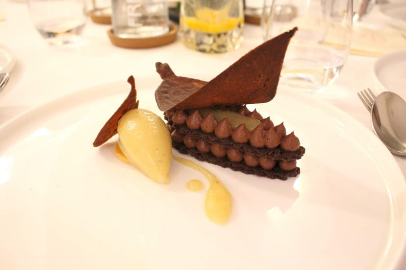 Elegant layered chocolate dessert plate with sorbet for events at Le Gourmet de Sèze.