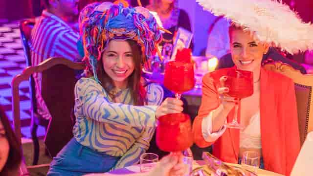 Péniche Volle Petrol at Mad Hatter's Tea Party with colorful drinks and festive atmosphere.