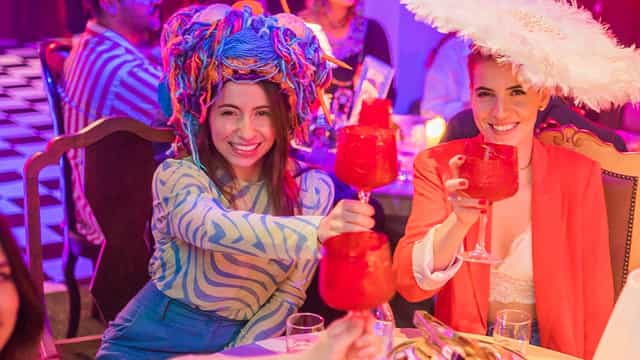 Péniche Volle Petrol at Mad Hatter's Tea Party with colorful drinks and festive atmosphere.