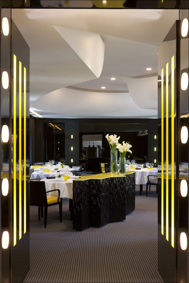 Elegant Bistro dining setup with floral centerpiece for upscale events and meetings.