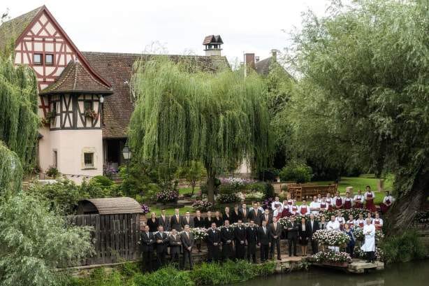 Outdoor wedding venue at Auberge de l'Ill with lush greenery and charming architecture.