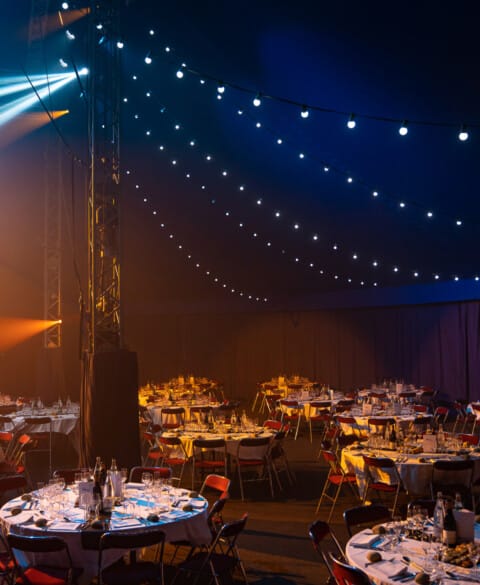 Elegant conference tent with circular tables, perfect for gatherings and events.