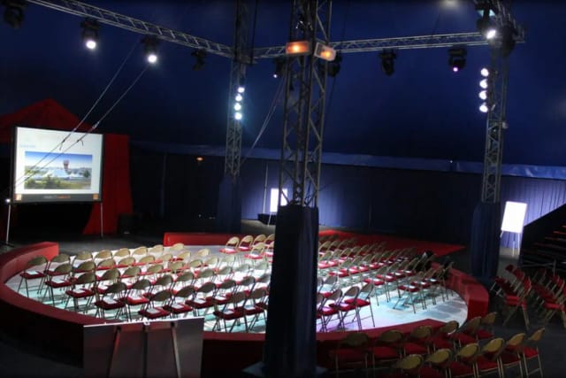 Conference tent with circular seating for innovative events and team-building activities.