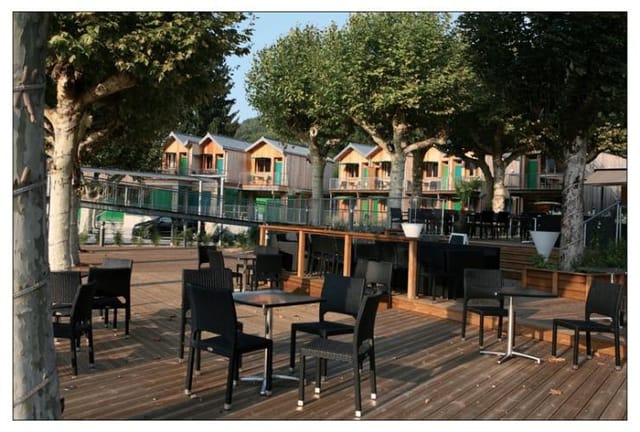 Outdoor event space at La Maison des Pêcheurs with modern seating and lush greenery.