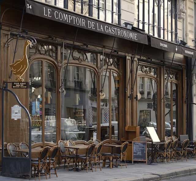 Charming restaurant façade with outdoor seating for intimate networking events.