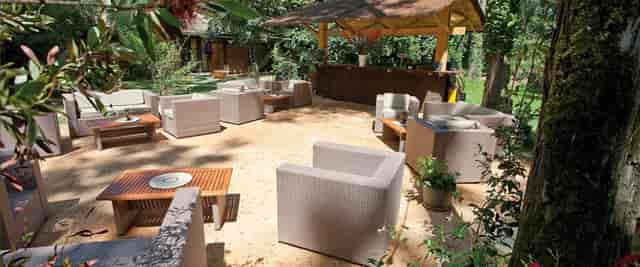 Outdoor lounge area at Les Jardins de l'Olympe for networking events and casual meetings.