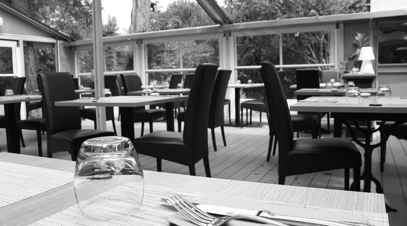 Chic modern restaurant interior with elegant table settings for networking events.