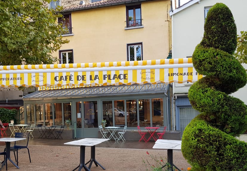 Charming café with yellow awning, perfect for networking and team-building events.