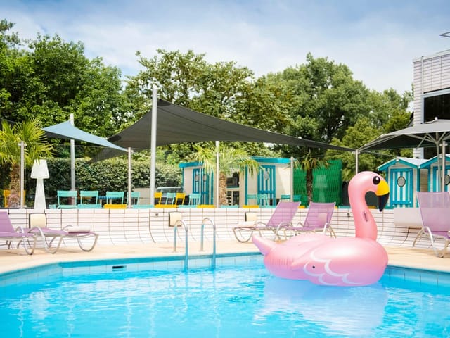 Vibrant pool area with flamingo float for summer events at Novotel Lyon Gerland.