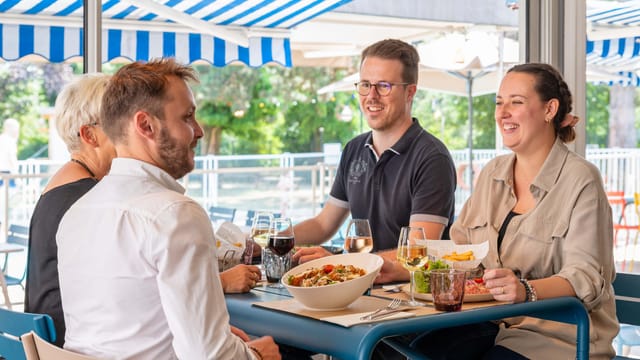 Lively networking event at Jardin & Company with outdoor dining and casual atmosphere.