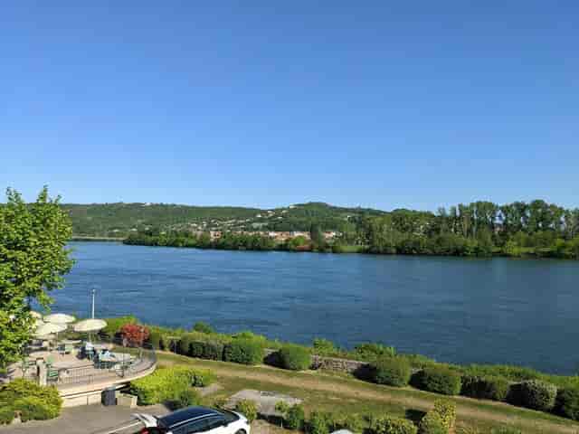 Serene riverside terrace at Le Beau Rivage, ideal for outdoor conferences and retreats.