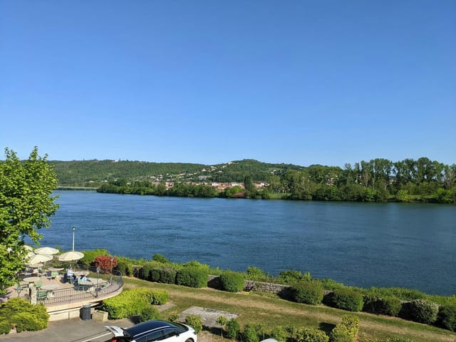 Serene riverside terrace at Le Beau Rivage, ideal for outdoor conferences and retreats.