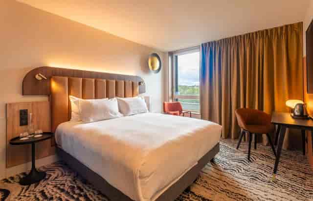 Modern hotel suite at DoubleTree Lyon Eurexpo, ideal for meetings and retreats.