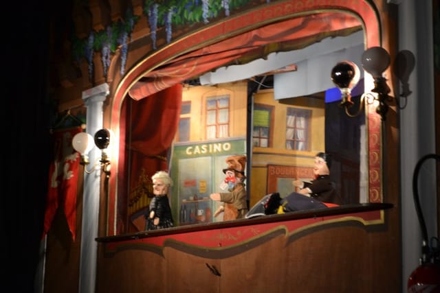 Puppet show stage with vibrant backdrop for family-friendly events in Lyon.