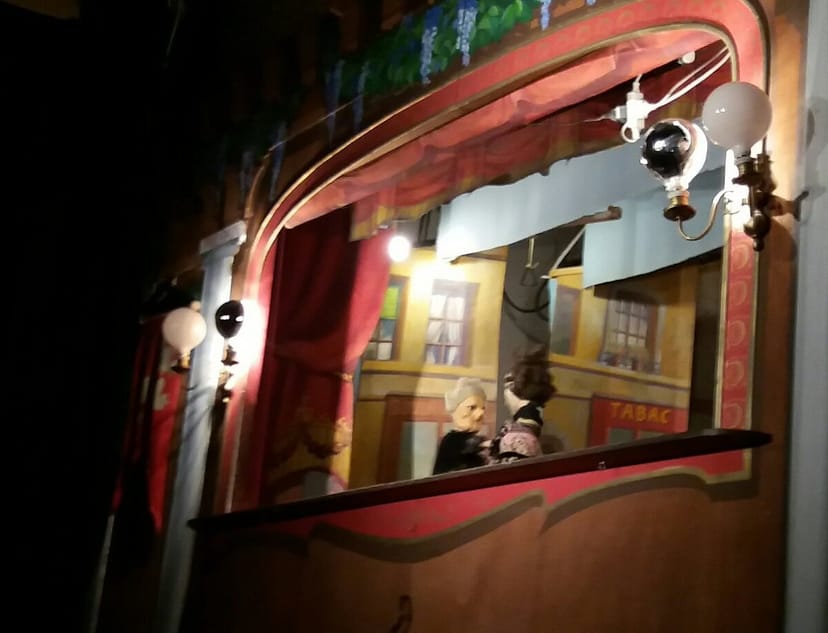 Puppet show at La Maison de Guignol Lyon with whimsical backdrop for children's events.