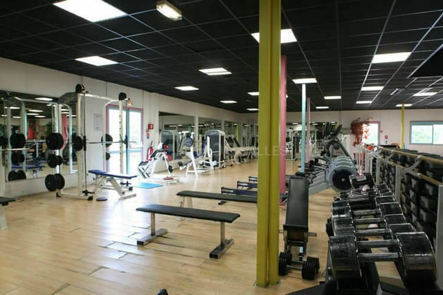 Spacious fitness center at Hôtel Léonard de Vinci for wellness events and corporate retreats.