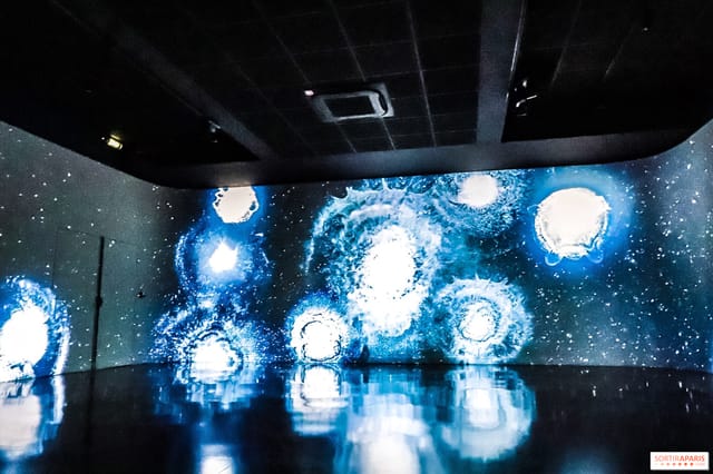 Immersive cosmic backdrop at L'Atelier des Lumières for modern events and conferences.