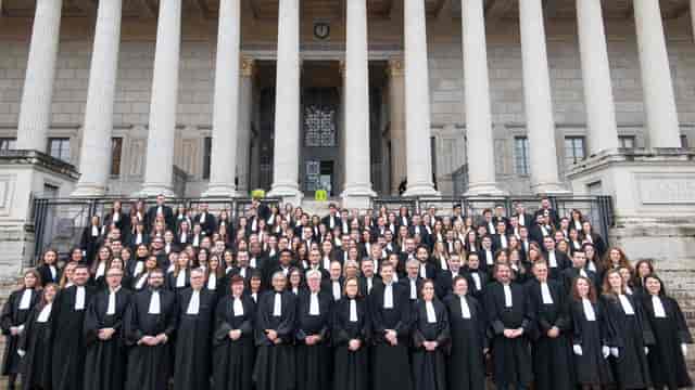 Yves BERGER with legal professionals at a formal event outside a grand building.