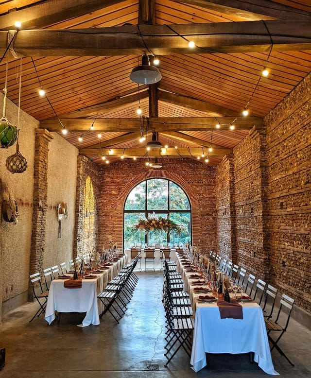 Elegant event space with rustic brick walls, ideal for weddings and corporate gatherings.