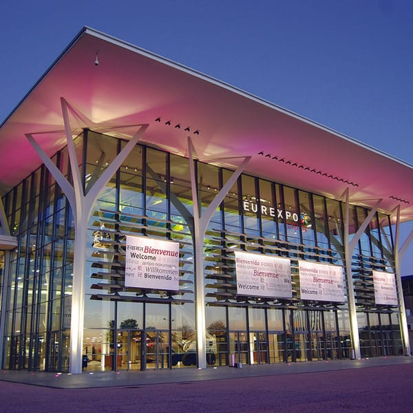 Modern Eurexpo Lyon convention center with vibrant lighting for trade shows and conferences.