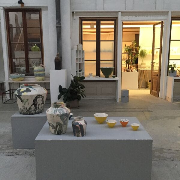 "Exhibition Hall at L'USINE: vibrant ceramics display for creative workshops and events."
