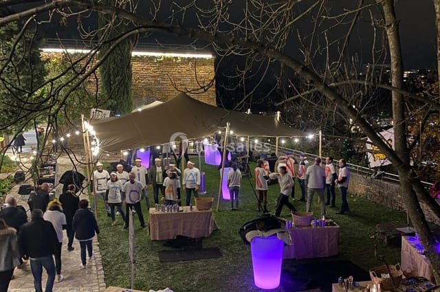 Tony Garnier outdoor event with tent and warm lighting, ideal for networking celebrations.