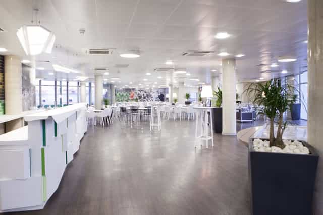 Contemporary event space with natural light, ideal for corporate meetings and social events.