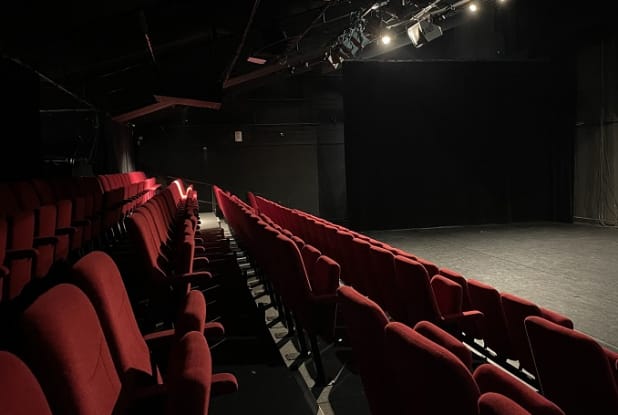Intimate Théâtre de La Renaissance stage with red seating, perfect for performances and presentations.