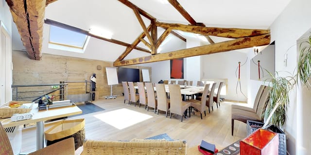 Bright function room with exposed beams, perfect for meetings and events at L'Hermitage de Moly.
