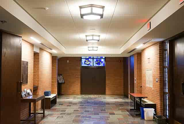 Spacious hallway with stained glass at First Presbyterian Church, ideal for events and networking.